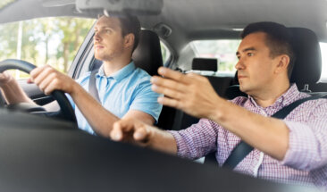 Trainer and student in car on road