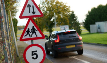Car on road with school signs